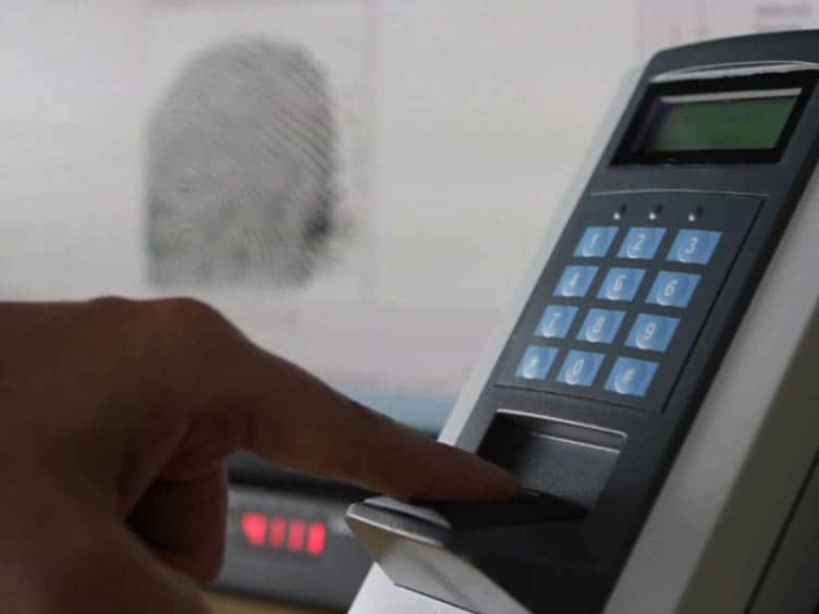 A man giving his fingerprint impression for biometrics access control