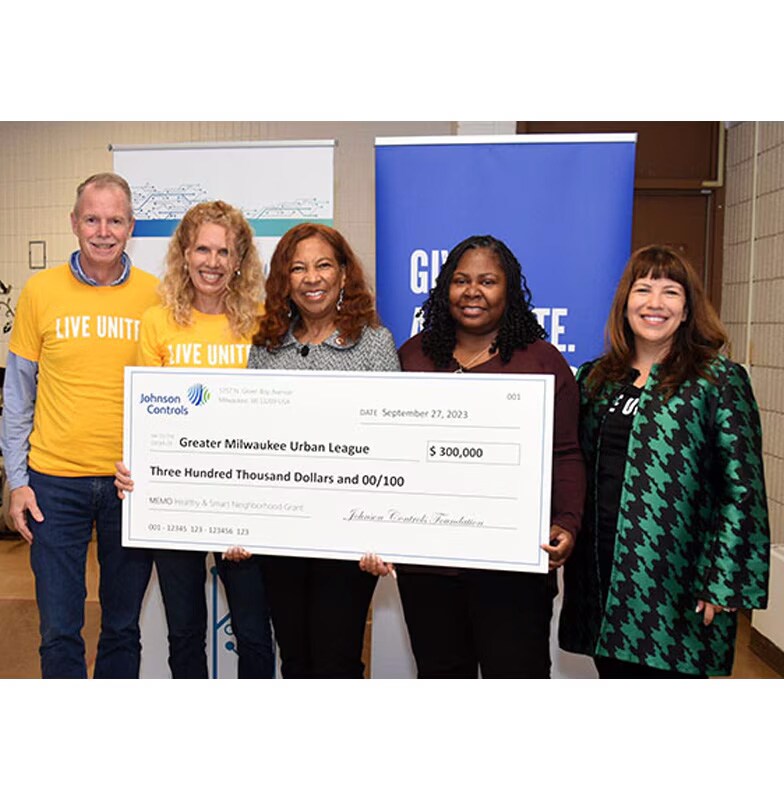 George Oliver posing with Johnson Controls four Smart and Healthy Neighborhood grants