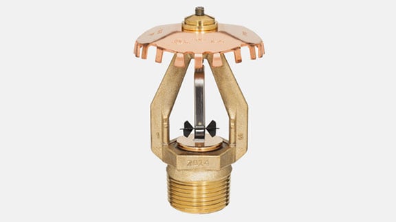 a golden sprinkler on grey background