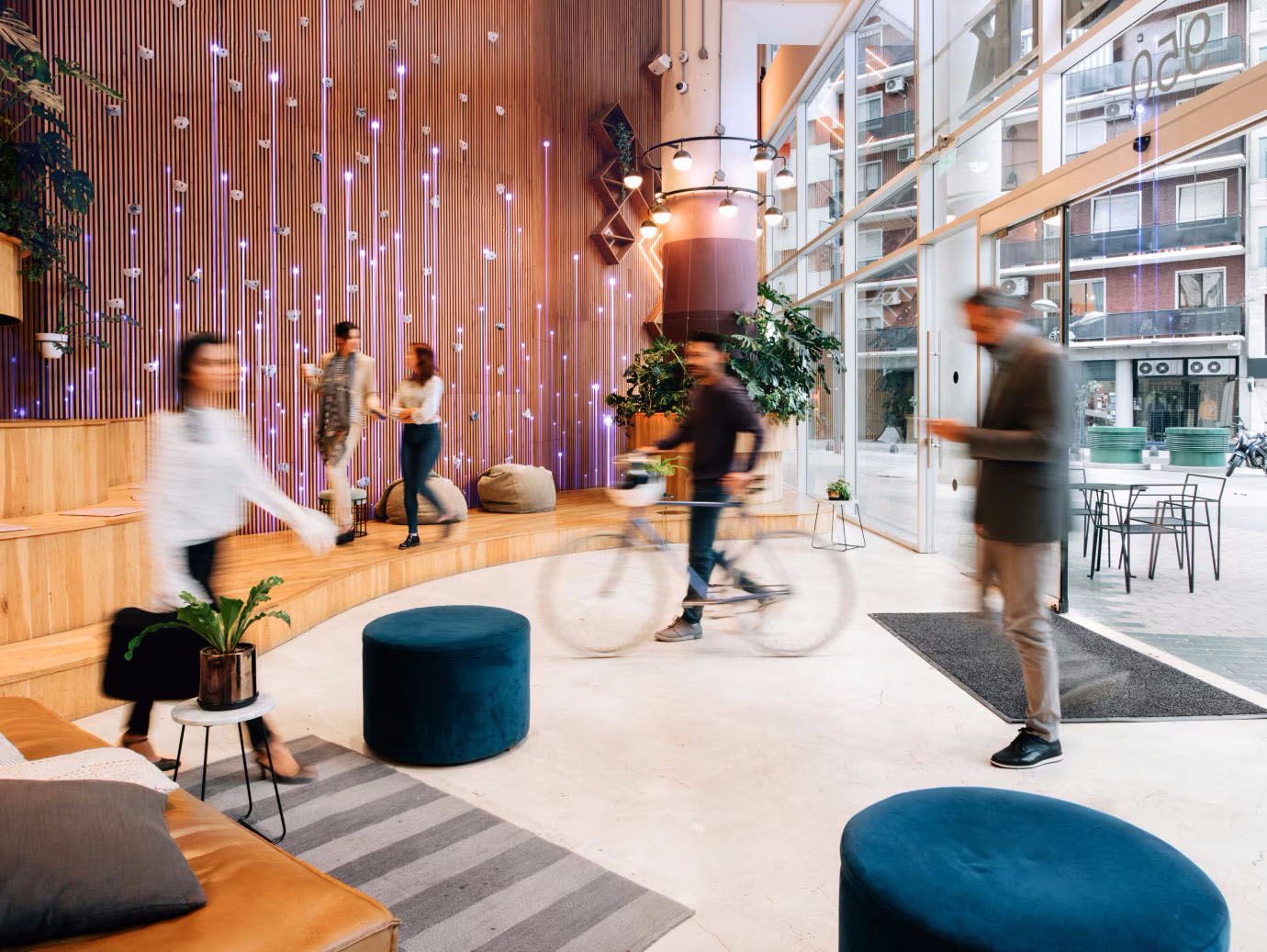 Interior of a crowded reception in a building, with OpenBlue graphics overlaid in the left