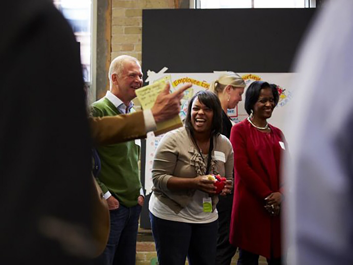 Group of employees laughing and enjoying a workshop