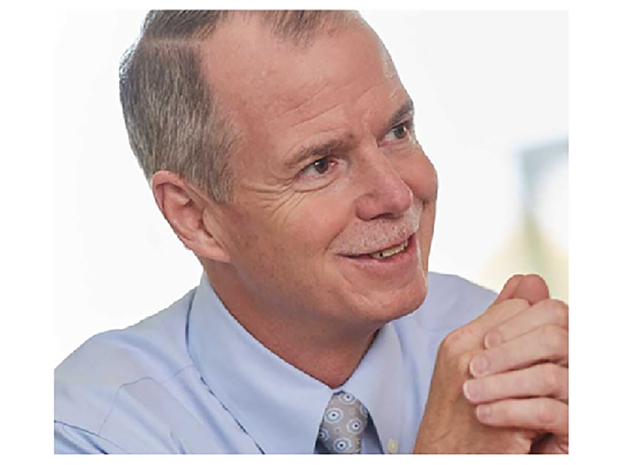George Oliver, chairman and CEO of Johnson Controls, smiling during an interview